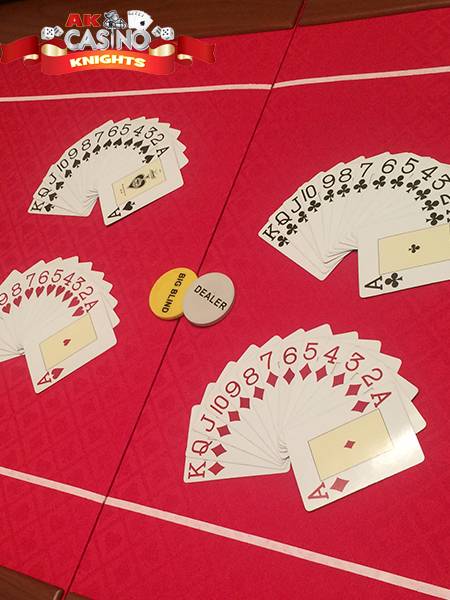 Poker table, texas holdem with card suits laid out