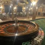 A Roulette table and wheel with chips at a party